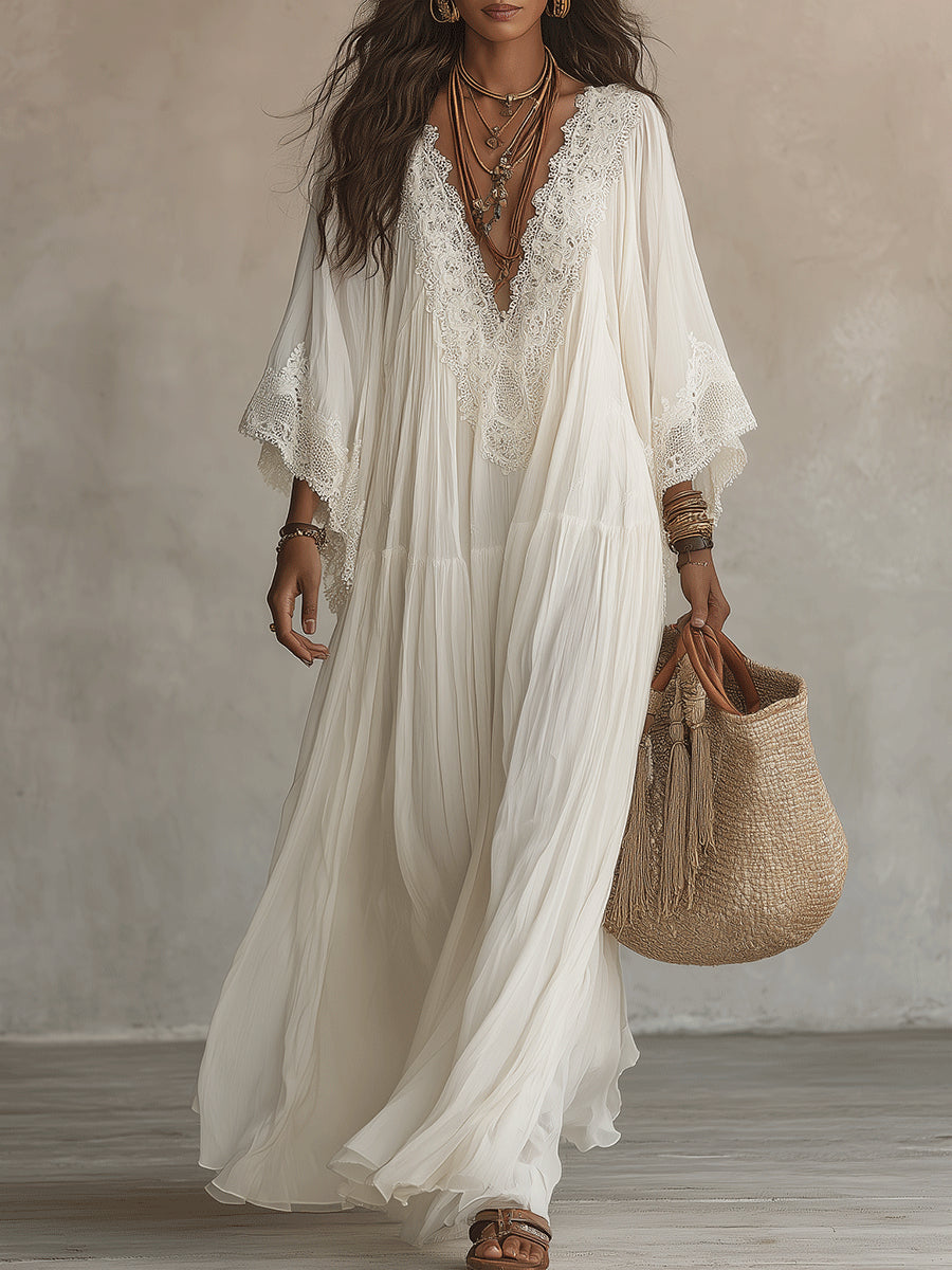 Elegant woman enjoying a summer day, wearing the flowing Ianthe lace V-neck maxi dress in ivory.