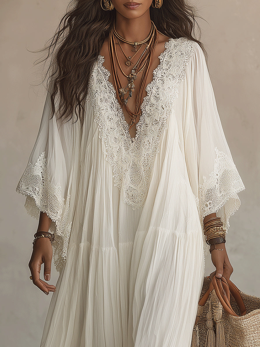 Detailed shot of the soft, light ivory fabric texture of the Ianthe maxi dress, showcasing its fluid drape.