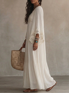 Rear view of the graceful ivory Ianthe maxi dress, highlighting its airy fall and comfortable silhouette.