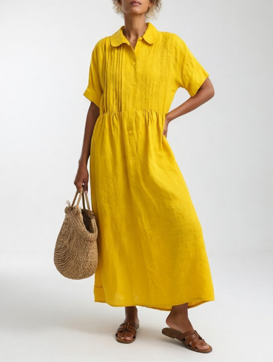 Yellow relaxed cotton shirt dress styled for a casual outing, detailing the front buttoning and shirt collar.