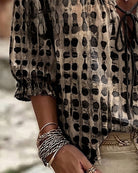 Lilac polka dot blouse, styled with a wide-brimmed hat, exuding a relaxed summer vibe.