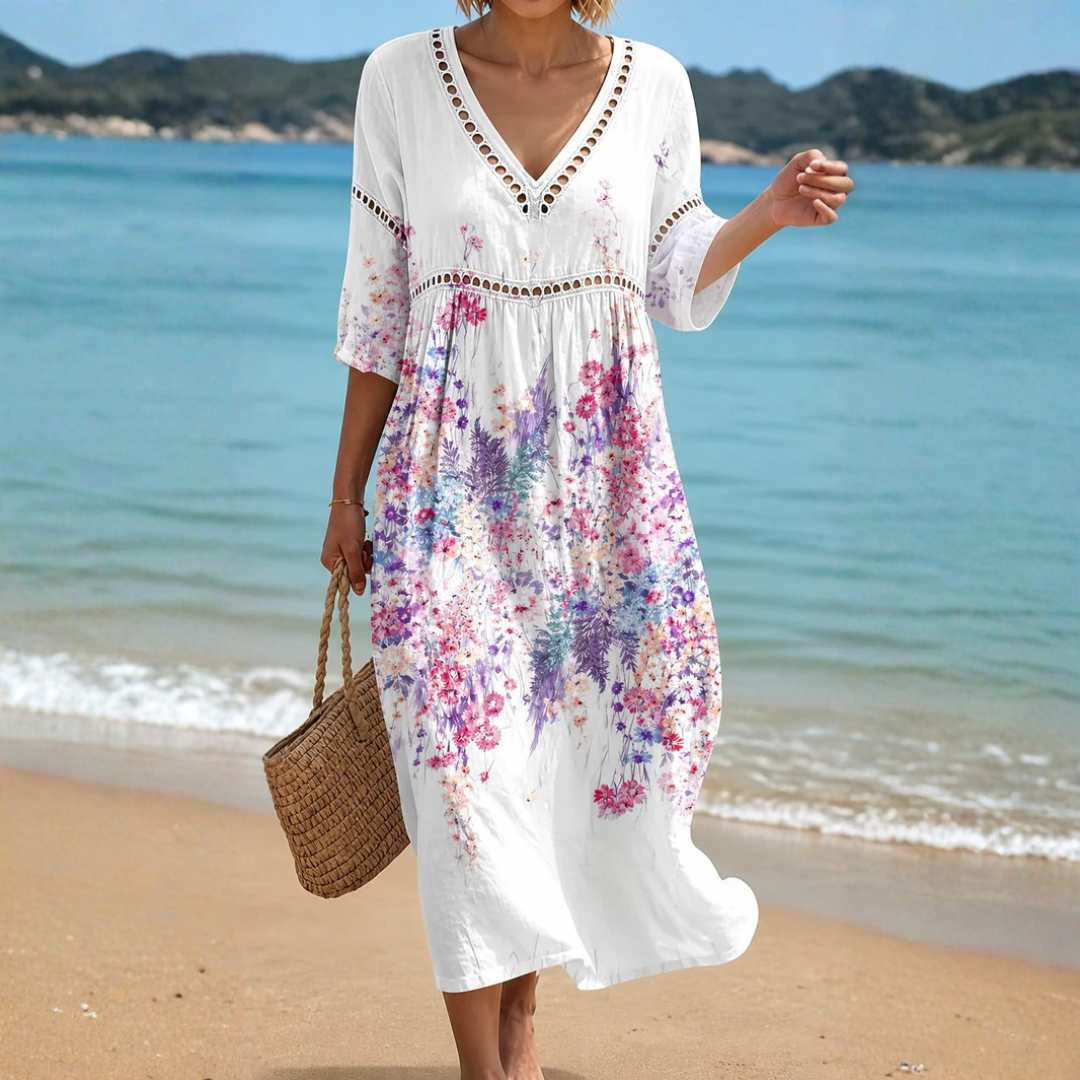 A woman models the Adalyn lightweight midi dress, showcasing its flowing silhouette and breathable fabric in a relaxed setting.