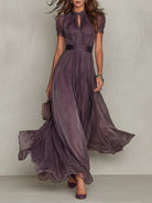Front view of a woman wearing the purple chiffon lace maxi dress, showcasing the keyhole neckline and flowing skirt.