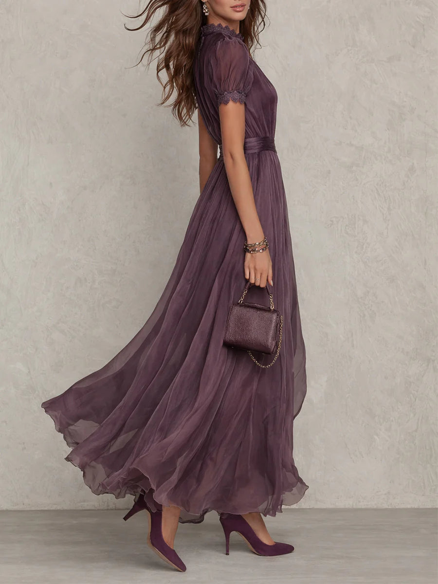 Side profile of the elegant purple chiffon maxi dress, highlighting the defined waist and delicate lace trim on the hem.