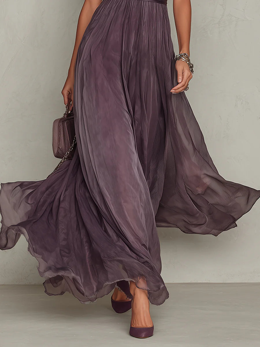 Lifestyle shot of the purple chiffon lace maxi dress in a garden setting, emphasizing its suitability for outdoor events.