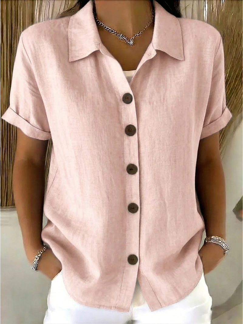 Close-up detail of the classic collar and button-front closure on the pink Daphne shirt.