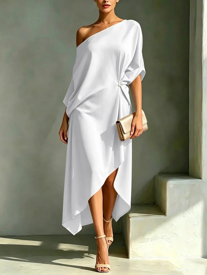 A woman wearing a yellow asymmetrical midi dress, styled with sandals and jewelry, enjoying an outdoor summer event.