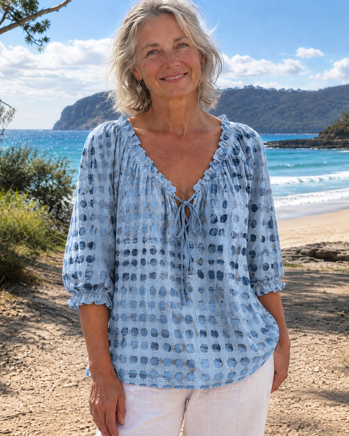 Mist blue blouse, highlighting the airy fabric texture and loose, comfortable fit for warm weather.