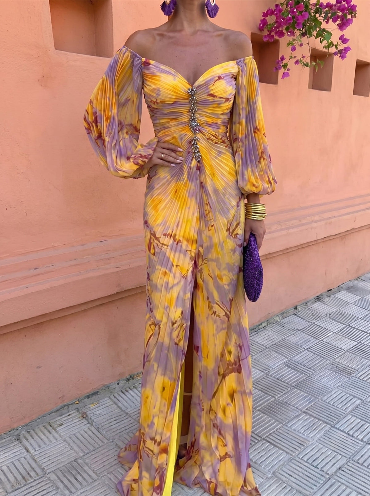 Close-up detail of the warm-toned floral print on the lightweight fabric of the elegant maxi dress.