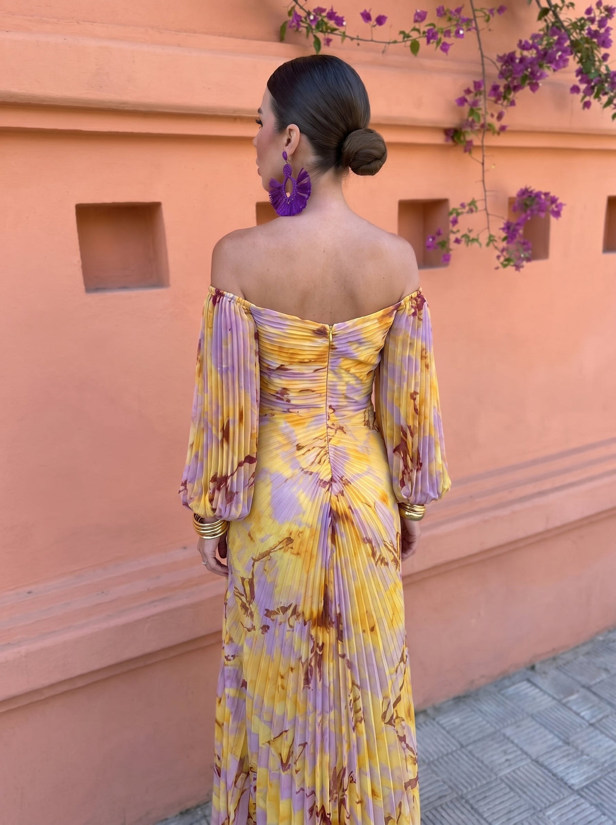 Side view of the woman in the tummy-flattering floral maxi dress, highlighting the graceful side slit and fit.