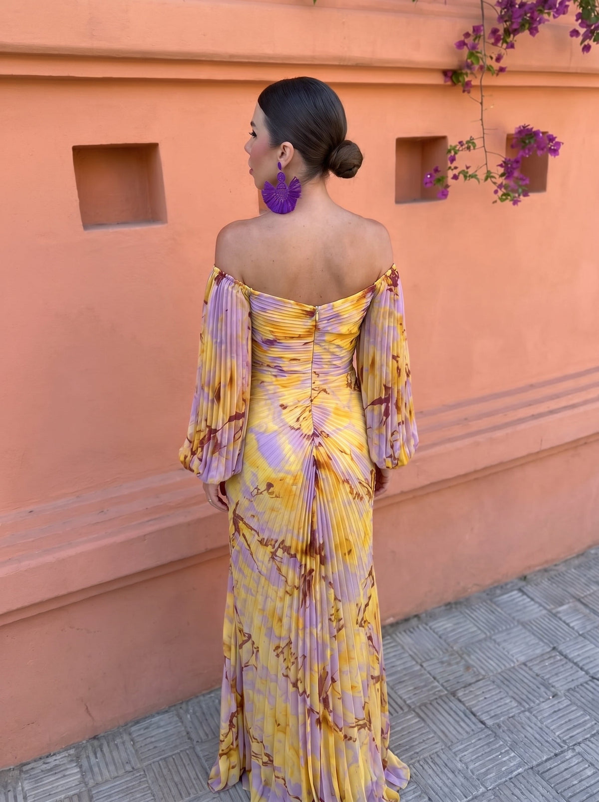 Woman styled with accessories, enjoying an outdoor event in the versatile floral maxi dress, radiating confidence.