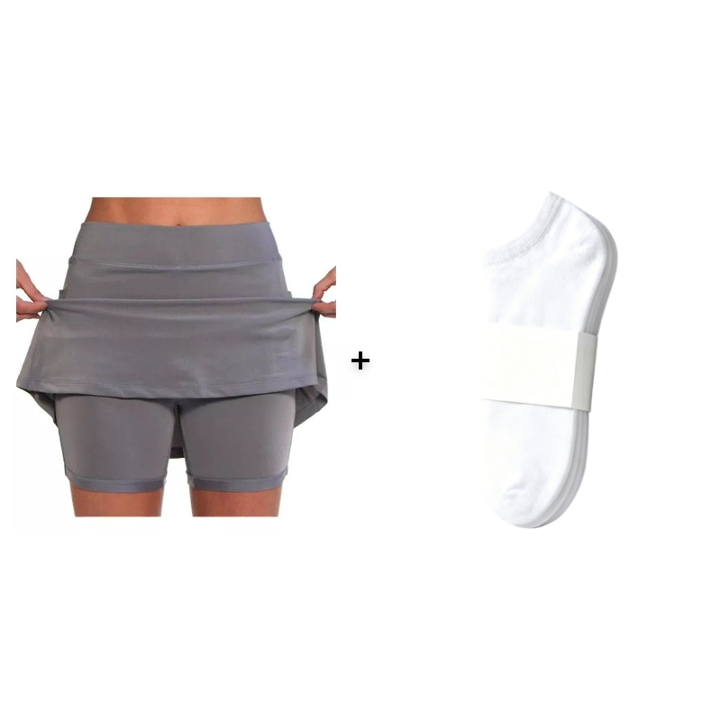 A detailed view of the integrated shorts inside the orange active skort, preventing chafing.