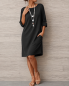 Close-up detail of the breathable fabric on the black midi dress, highlighting its soft texture and quality.