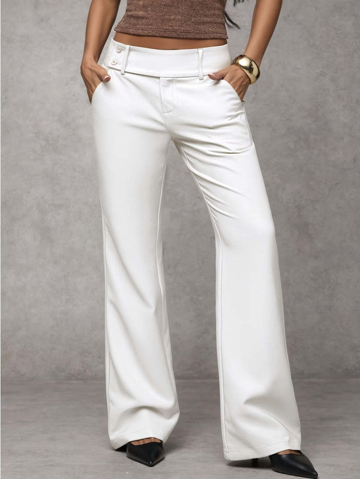 Rear view of a model in Indira black trousers, showcasing the back silhouette and overall design.