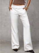 Rear view of a model in Indira black trousers, showcasing the back silhouette and overall design.