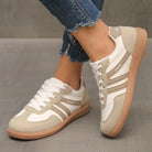 Pair of off-white Elara orthopaedic cushioned trainers displayed on a clean white surface, front-facing view.