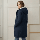 Back view of the Elara waterproof parka, emphasizing the smooth fabric and hood structure.