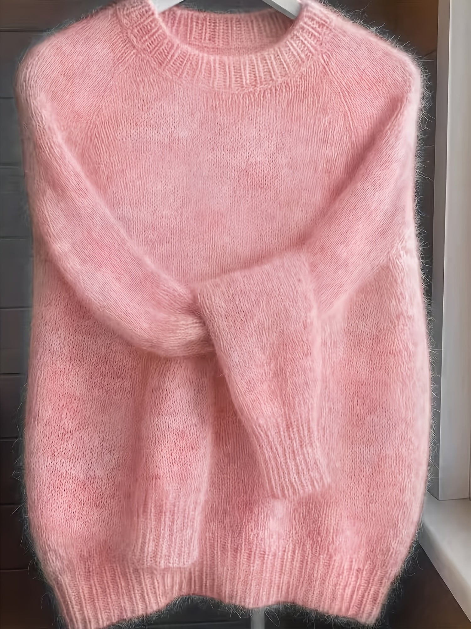 Side profile of the Elara cashmere-blend sweater in light grey, demonstrating its elegant drape and silhouette.