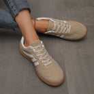 Overhead shot of the off-white Elara orthopaedic cushioned trainers, showing the overall shape and design.