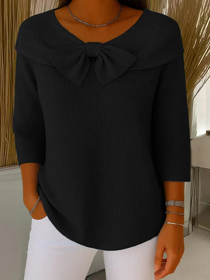 Back view of the Elara elegant knitted top in black, illustrating the smooth knit and overall silhouette.