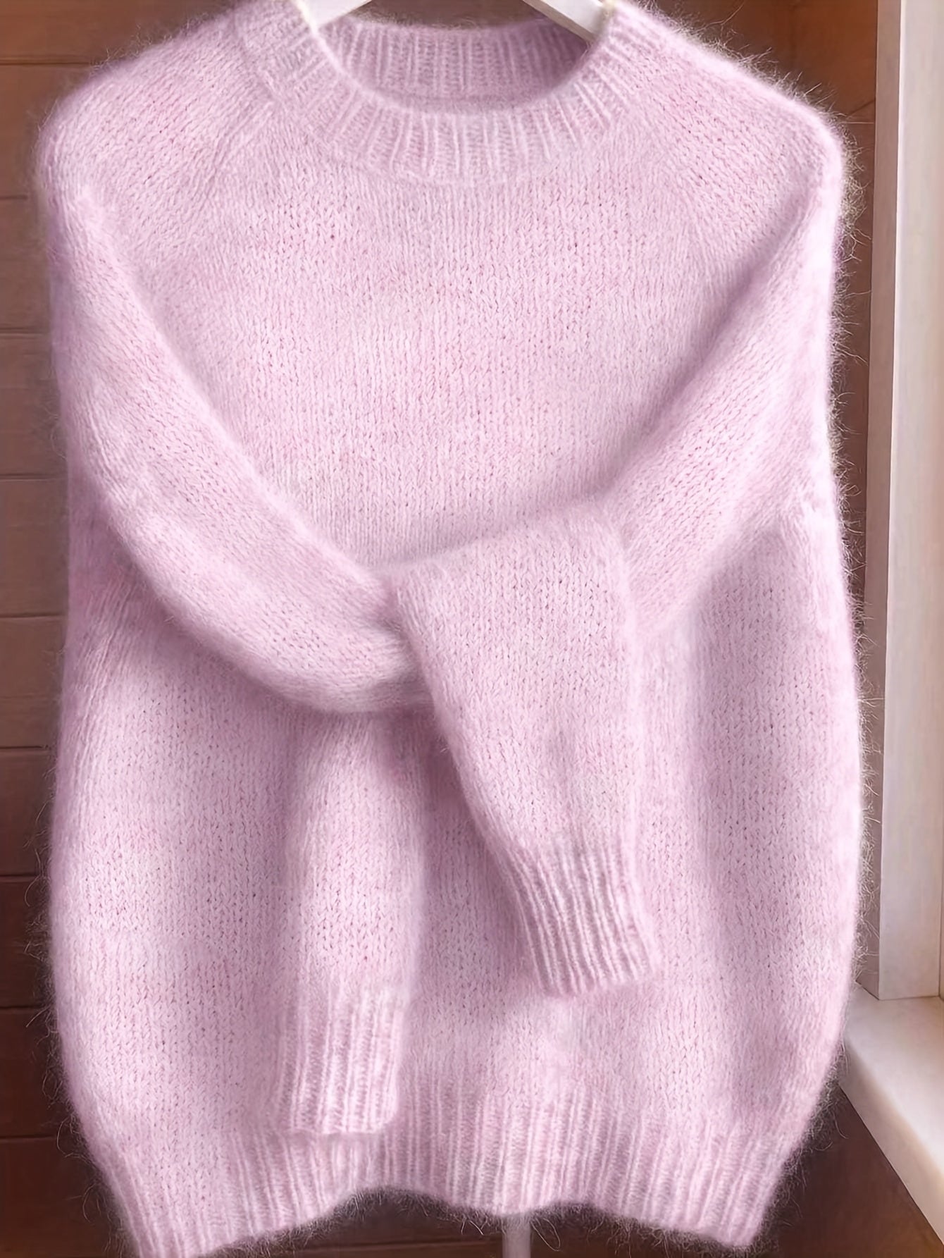 Back view of the Elara cashmere-blend sweater in soft pink, showing the smooth, even knit from behind.