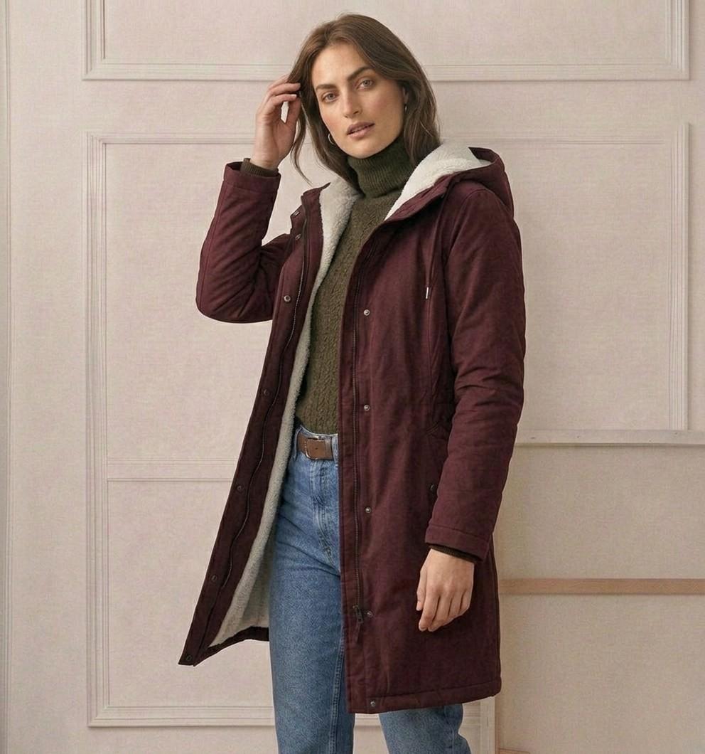 View of the Elara parka's full-length zipper with the button-down storm flap for complete wind protection.