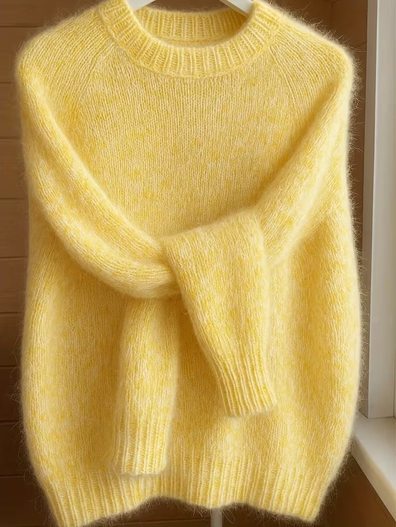Lifestyle image of a woman comfortably wearing the Elara cashmere-blend sweater while reading a book indoors.