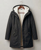 Detailed image of the deep, fixed storm hood on the Elara parka, designed for maximum face protection.