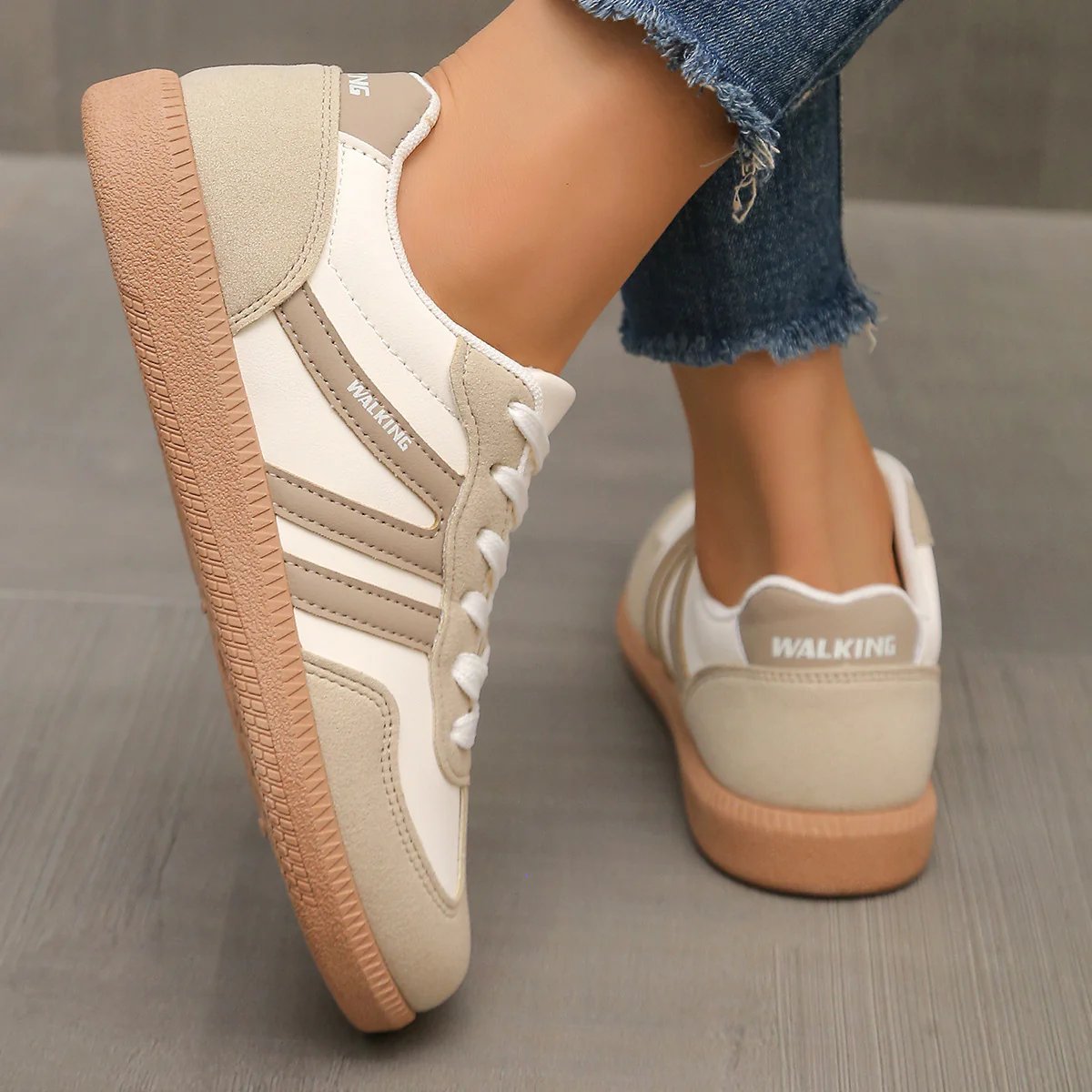 Arrangement of off-white and black Elara orthopaedic cushioned trainers side by side, showcasing color options.