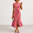 Side profile of a woman wearing the Kiera draped midi dress, emphasizing the graceful flared hem and movement.