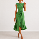 Detail of the high, rounded neckline and shoulder line of the Kiera elegant draped midi dress, with earrings.