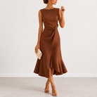 Model walking in the Kiera elegant draped midi dress, illustrating the asymmetric hemline and dynamic movement.