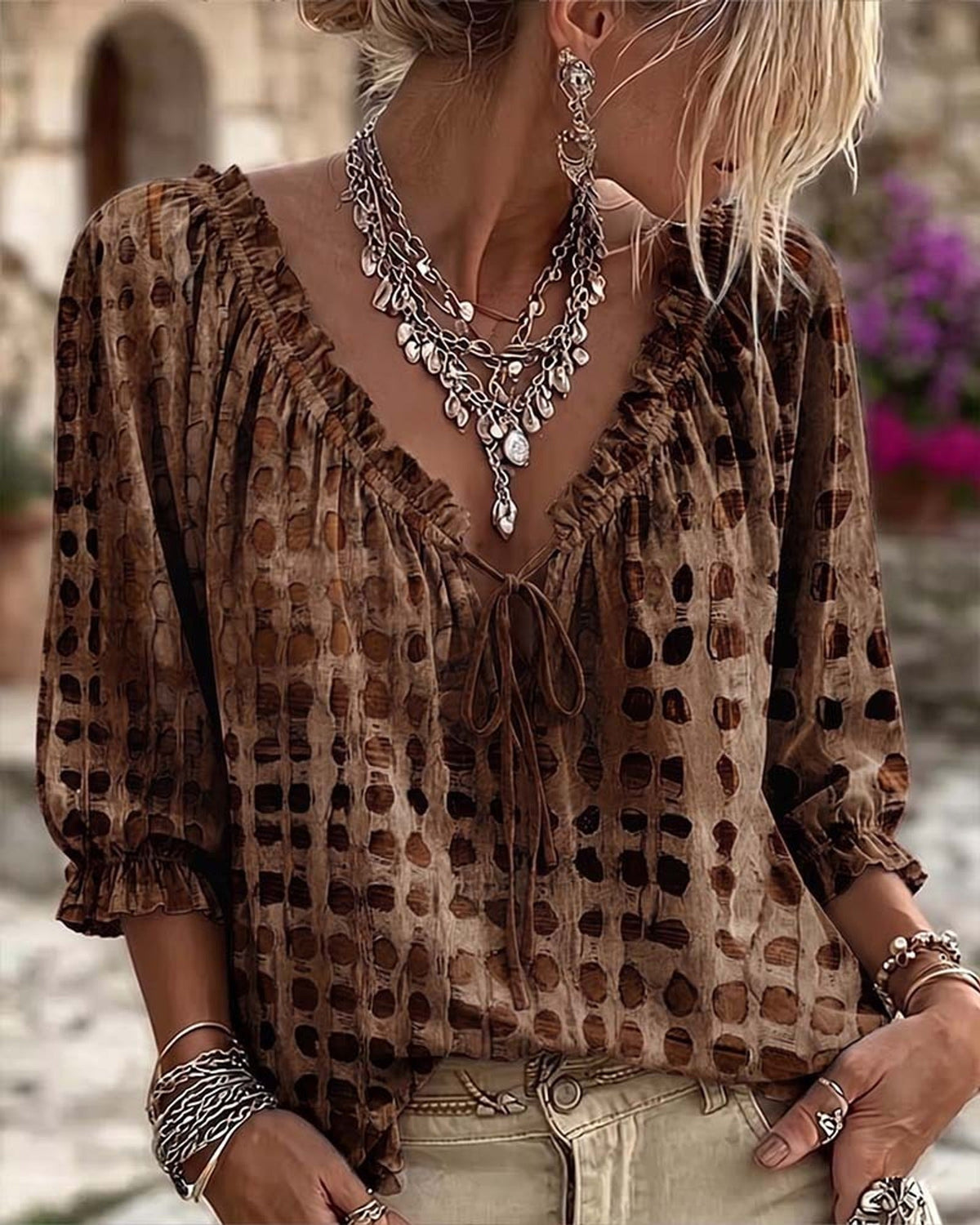 Lilac polka dot blouse, detail of the V-neckline and delicate ruffle embellishment.