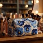 Front view of the Fiona quilted cosmetic bag in viole del pensiero print, showcasing its elegant design and texture.