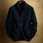 Detailed shot of the functional front pocket on the Florian men's wool blend cardigan, with hands casually placed.