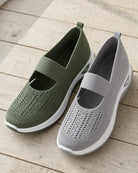 Green and grey Carry knit slip-ons side by side on a timber floor
