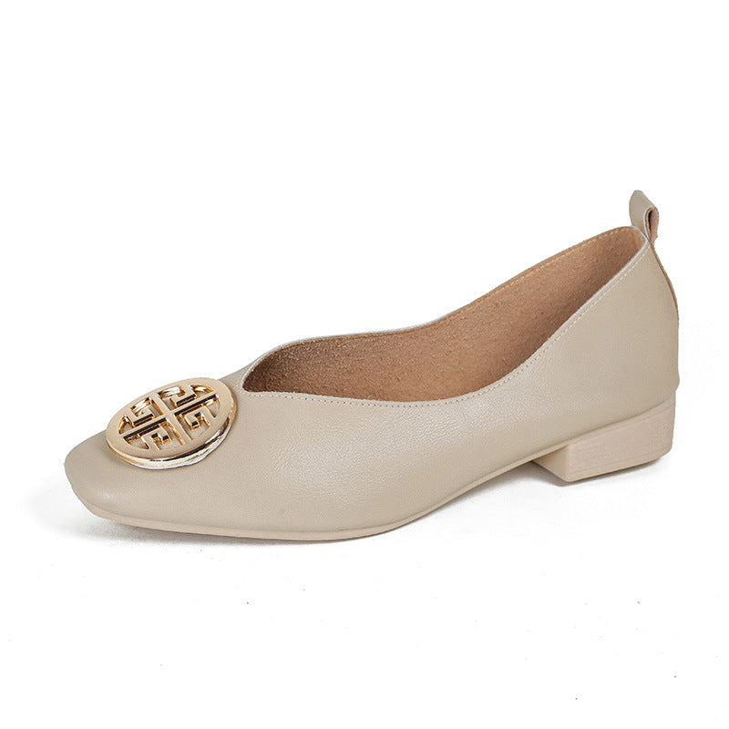 Elegant beige square-toe flats placed on a light wooden floor, ready for a day of comfortable wear.