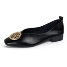 Detail shot of the microfiber texture and faux-leather insole of the comfortable square-toe flats.