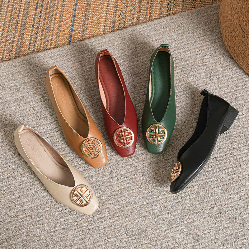 A pair of black square-toe flats worn by a model walking, showing natural movement and fit.