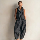 Front view of the Hazel utility sleeveless jumpsuit in black, showcasing the stand-up collar and button placket.
