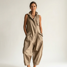 Model wearing the black utility sleeveless jumpsuit, styled casually for a daytime outing, emphasizing comfort.