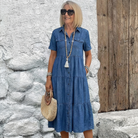 Woman walking outdoors, demonstrating the flowing movement of the tiered skirt on the Navy Blue Odelia tiered midi dress.