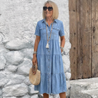 Front view of a woman wearing the Sky Blue Odelia tiered midi dress, showcasing its relaxed fit and button-front design.