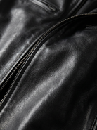 Side profile of the Hugo men's leather jacket, highlighting the tailored fit and arm details.