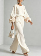 Dynamic shot of wide-leg trousers in motion, capturing the fabric's drape and lightweight feel.