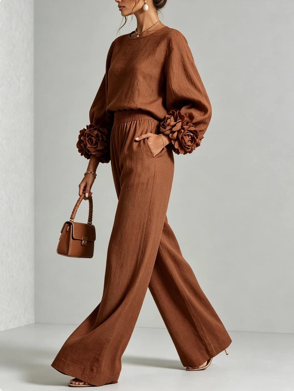 Folded pair of elegant wide-leg trousers, displaying the wide hem and relaxed cut.