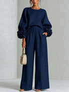 Styled shot of versatile brown wide-leg trousers paired with minimalist accessories, suitable for various occasions.