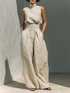 Side profile of olive green wide-leg trousers, emphasizing the spacious leg design and smooth lines for comfort.