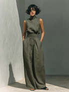 Pair of blush pink cotton wide-leg trousers folded neatly, revealing the soft material and inviting color.