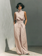 Overhead view of light blue cotton trousers laid flat, displaying the wide leg and overall relaxed shape.